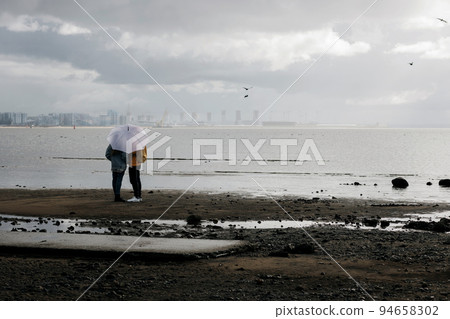 couple kissing behind the umbrella couple kissing behind the umbrella 94658302