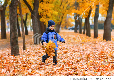 Child boy running in autumn city park. Beautiful nature, trees with yellow leaves. Child boy running in autumn city park. Beautiful nature, trees with yellow leaves. 94659662