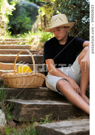 boy with a basket of melons 94660685