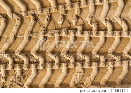 Tyre tracks on brown sand in construction site Tyre tracks on brown sand in construction site 94661154