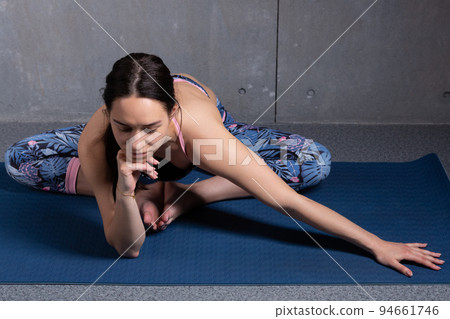 girl in the gym performs yoga exercises, the concept of an active lifestyle girl in the gym performs yoga exercises, the concept of an active lifestyle 94661746