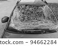 Damaged and destroyed civilian car with shrapnel holes from Russian missile in a war zone in Kharkiv, Ukraine 94662284