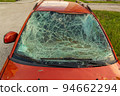 Damaged and destroyed civilian car with shrapnel holes from Russian missile in a war zone in Kharkiv, Ukraine 94662294