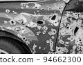 Damaged and destroyed civilian car with shrapnel holes from Russian missile in a war zone in Kharkiv, Ukraine 94662300