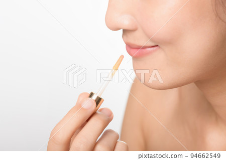 Portrait young asian woman looking mirror applying makeup lipstick at room 94662549