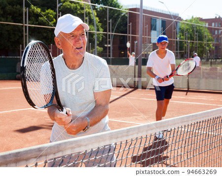 grandfather and grandson playing tennis court grandfather and grandson playing tennis court 94663269