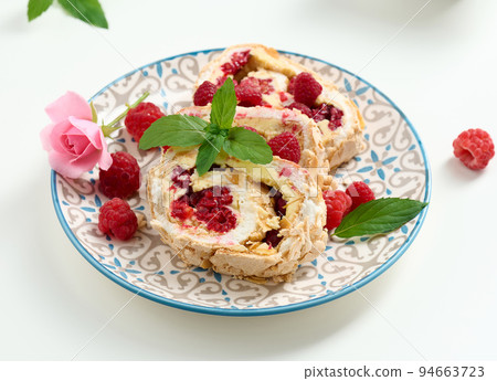 Baked meringue roll with cream and fresh red raspberry, white background Baked meringue roll with cream and fresh red raspberry, white background 94663723