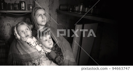 Frightened children with their mother hide in the cellar from the bombings. Kyiv. Ukraine. 8 May 2022 94663747