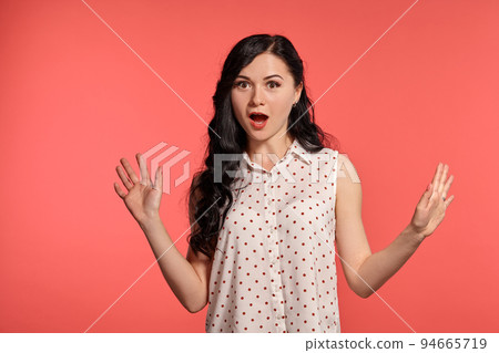 Studio shot of a beautiful girl teenager posing over a pink background. 94665719
