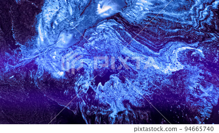 Bright blue neon paint spreads. Abstract colorful blue glowing liquid explosion over dark surface. Action particles on dark area background. Mix ink art blast. Blue flowing paint Bright blue neon paint spreads. Abstract colorful blue glowing liquid explosion over dark surface. Action particles on dark area background. Mix ink art blast. Blue flowing paint 94665740