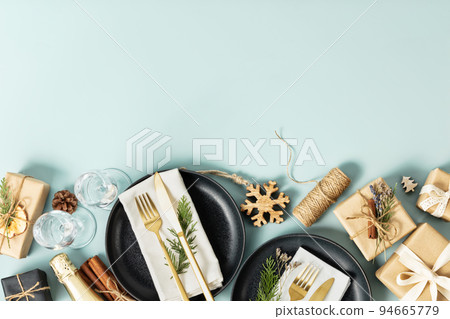 Christmas table place setting on blue background flat lay copy space 94665779
