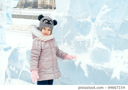 cute little caucasian girl with ice sculptures 94667154