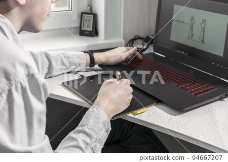 digital artist man working on 3d graphics using a graphics tablet 94667207