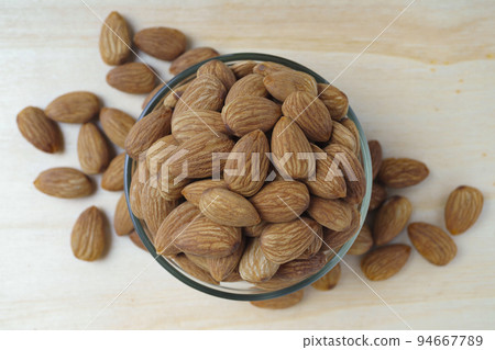 almonds in a bowl on a wooden table almonds in a bowl on a wooden table 94667789
