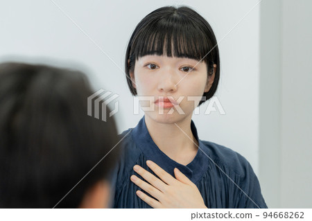 Close-up of the face of a young woman receiving counseling Close-up of the face of a young woman receiving counseling 94668262