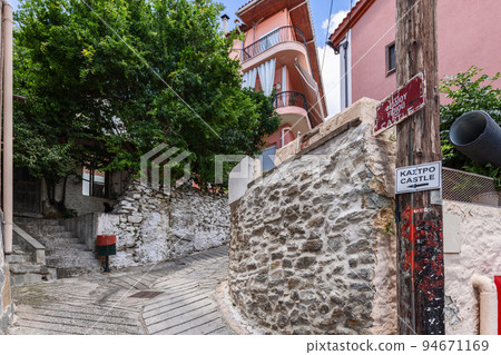 street paved with cobblestones decorated by plants and trees leads uphill to Castle street paved with cobblestones decorated by plants and trees leads uphill to Castle 94671169