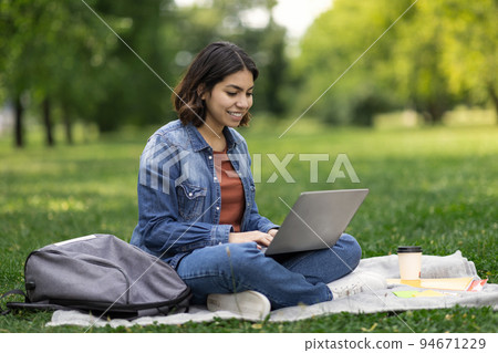 Distance Learning. Young Middle Eastern Female Student Study With Laptop Outdoors 94671229