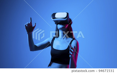 Creative engineer woman working with virtual reality. Young woman testing VR glasses or goggles in studio. Creative engineer woman working with virtual reality. Young woman testing VR glasses or goggles in studio. 94671531