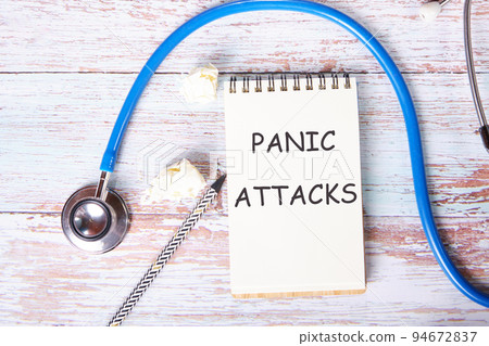 PANIC ATTACK text in a notebook on the table. The concept of medicine and health. 94672837