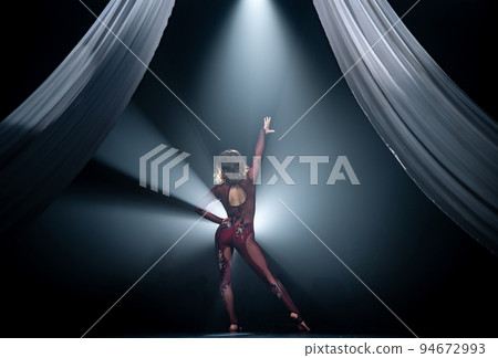 Beautiful female dancer with white silks on the stage. Show, art and performance concept 94672993