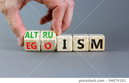 Altruism or egoism symbol. Concept words Egoism and Altruism on wooden cubes. Psychologist hand. Beautiful grey table grey background. Business psychological altruism or egoism concept. Copy space Altruism or egoism symbol. Concept words Egoism and Altruism on wooden cubes. Psychologist hand. Beautiful grey table grey background. Business psychological altruism or egoism concept. Copy space 94674191