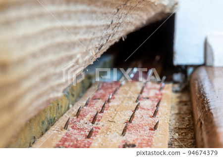 Carpet tack strip exposed during a flooring home improvement project 94674379