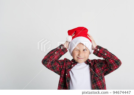 Smiling little boy in Santa's hat with gift box, isolated on white. 94674447