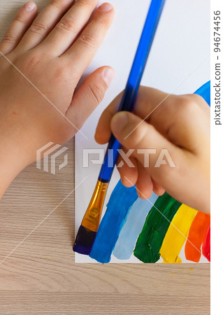 Multicolored rainbow with gouache paints. Children's drawing in their free time Multicolored rainbow with gouache paints. Children's drawing in their free time 94674456