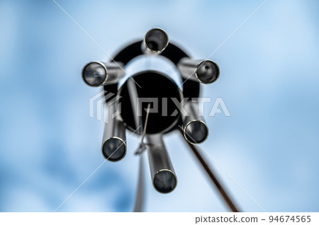 Looking up to the sky underneath a spinning wind chime. Looking up to the sky underneath a spinning wind chime. 94674565