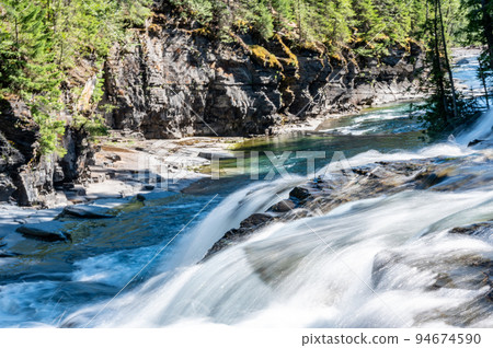 Cascades and rushing water in Avalanche Creek at Glacier National Park, Montana.  94674590