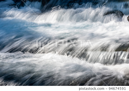 Cascades and rushing water in Avalanche Creek at Glacier National Park, Montana.  94674591