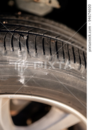 screw protruding from the tread of a tire causing a flat. 94674600