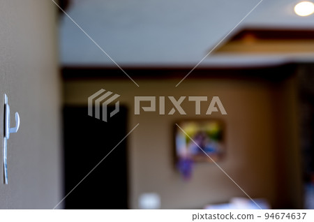 Selective focus on adhesive strip wall hanger that can be removed by pulling tape 94674637