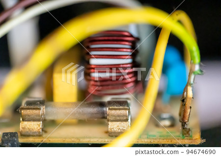 Brown damaged fuse that has blown and defective. 94674690