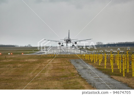 Plane landing on runway Plane landing on runway 94674705