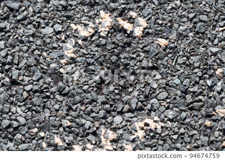Macro of hail damage on a shingle residential roof circled with a chalk outline during a home inspection. 94674759