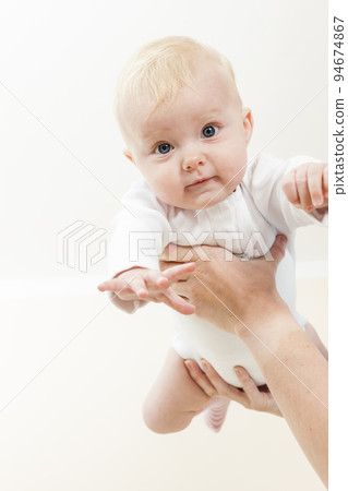portrait of little baby in mum's hands 94674867