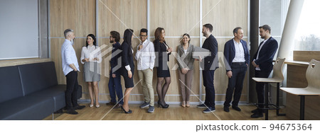 Diverse group of people communicating after business conference or corporate meeting Diverse group of people communicating after business conference or corporate meeting 94675364