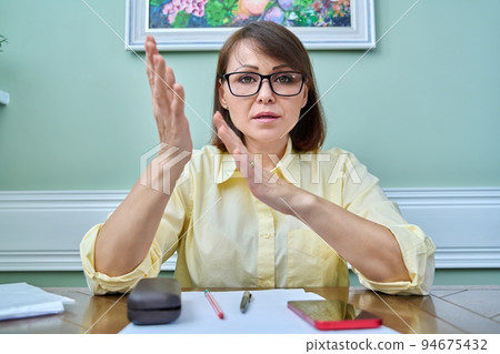 Web view of business mature woman looking at webcam 94675432