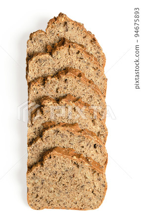 Overlapped slices of spelt bread, from above, on white background. Homemade and crusty baked, fresh dark bread, made of wholemeal spelt, bread spices, sunflower and flax seeds. Close-up food photo. Overlapped slices of spelt bread, from above, on white background. Homemade and crusty baked, fresh dark bread, made of wholemeal spelt, bread spices, sunflower and flax seeds. Close-up food photo. 94675893