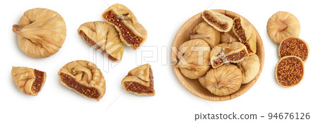 dried fig in wooden bowl isolated on white background. Top view. Flat lay dried fig in wooden bowl isolated on white background. Top view. Flat lay 94676126