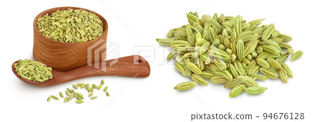 Dried fennel seeds in wooden bowl isolated on white background with full depth of field Dried fennel seeds in wooden bowl isolated on white background with full depth of field 94676128