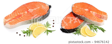 Slice of red fish salmon with lemon, rosemary and peppercorns isolated on white background Slice of red fish salmon with lemon, rosemary and peppercorns isolated on white background 94676142