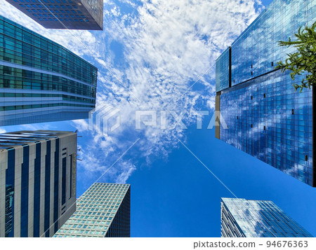 Blue sky seen through the forest of buildings 94676363