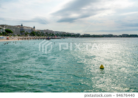 Amazing on Mediterranean sea from Croisette - people swimming . At far distamce bif shipcruiser on park Amazing on Mediterranean sea from Croisette - people swimming . At far distamce bif shipcruiser on park 94676440