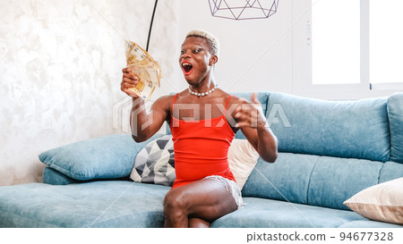 Excited African American person in stylish red dress with makeup examining bunch of money Excited African American person in stylish red dress with makeup examining bunch of money 94677328
