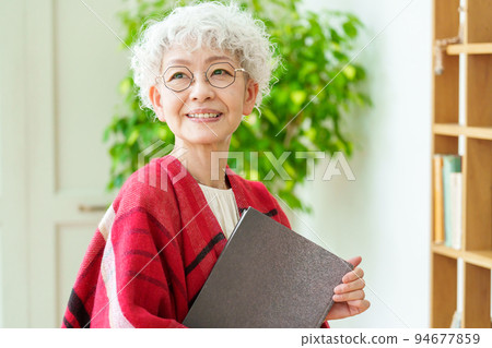 Gray-haired woman reading 94677859