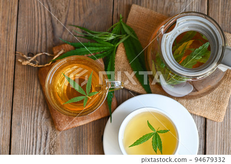 Cannabis tea herbal on tea cup with cannabis leaf marijuana leaves herb, Health tea with hemp leaf plant THC CBD herbs food and medical 94679332