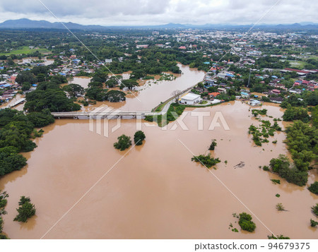 Aerial view river flood village countryside Asia and forest tree, Top view river with water flood from above, Raging river running down jungles lake flowing wild water after the rain 94679375