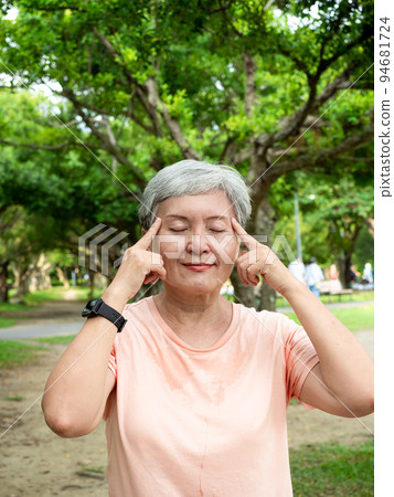 A 60-year-old Asian mature woman with a massage eye, enjoying the fresh air of nature in the park. A 60-year-old Asian mature woman with a massage eye, enjoying the fresh air of nature in the park. 94681724